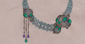 a necklace with green and purple beads on it
