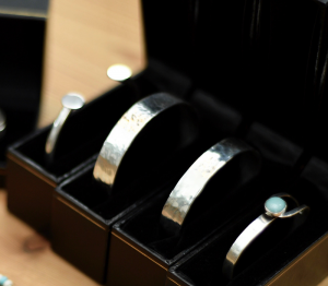 three silver rings in a black box on a table