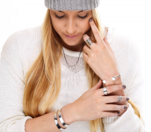 a woman with long blonde hair wearing a beanie