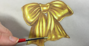 a drawing of a gold bow with a red marker