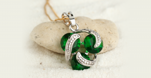 a green necklace with an intertwined knot on it