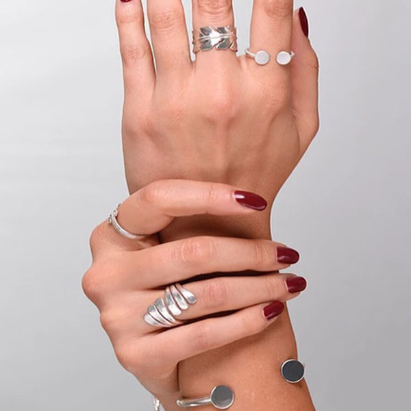 a woman's hand with rings on it