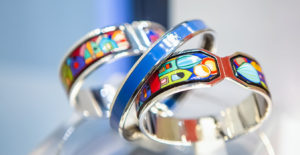 two rings with colorful designs on them sitting on a table