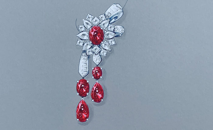 a brooch with red and white stones hanging from it
