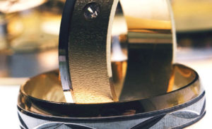 two wedding rings sitting on top of each other
