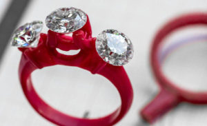 a pair of red rings with three diamonds on them