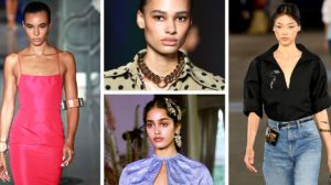 four different models wearing statement necklaces on the runway