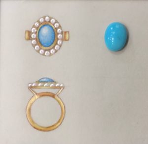 three rings and a turquoise stone on a white surface