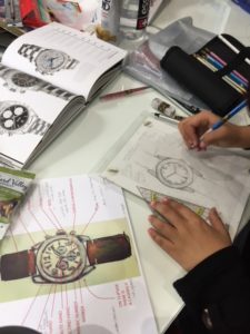 a person is working on a watch design