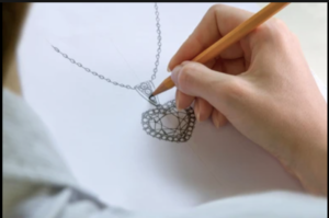 a woman is drawing on paper with a pencil