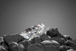 a diamond sitting on top of some rocks