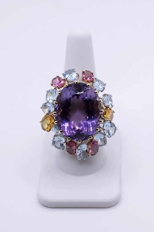 A jeweled broach with amethyst and aquamarine at NYJDI