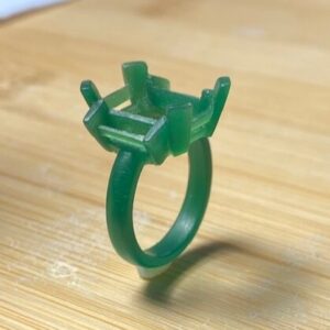 Student transforming a wax-carved 3 stone ring into a finished metal design.