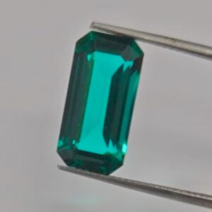 natural blue green indicolite tourmaline illuminates at NYJDI before being set into a ring.